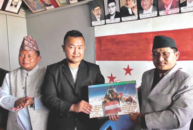 Photograph showing NC flag on top of Everest handed over to Panchthar party president